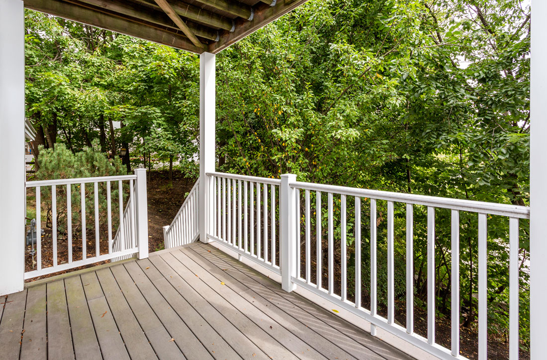 Large deck overlooking wooded yard